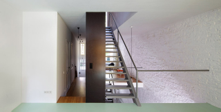 Illustration for article titled This Dream House Was Entirely Built Around a Giant Three-Story-High Bookshelf